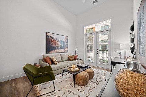 a living room with a couch and a door to a balcony